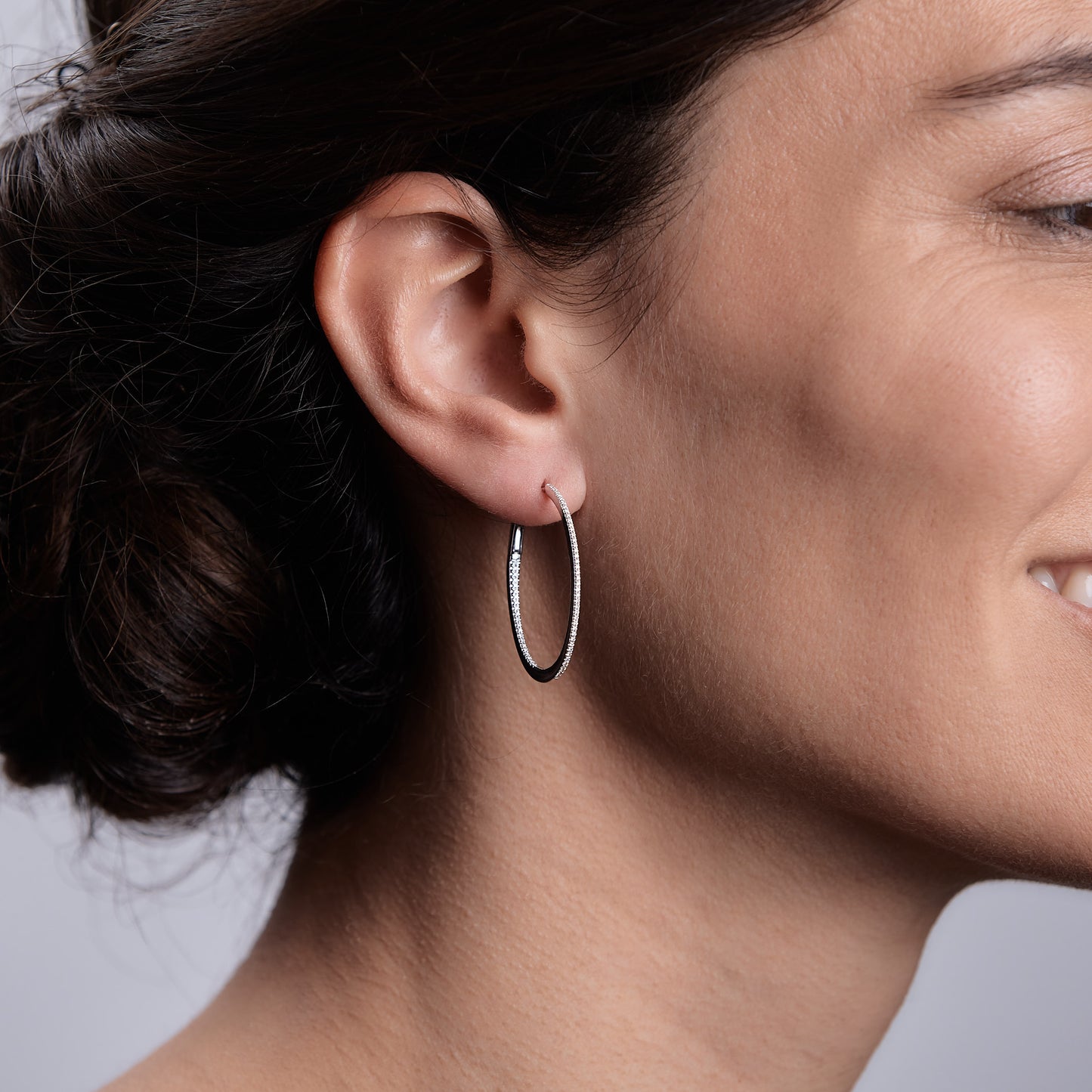 Woman wearing the Oliver Heemeyer Oakley diamond hoops 3,2 cm made of 18k white gold.