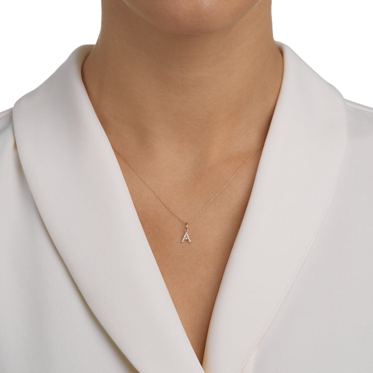 Woman wearing the Oliver Heemeyer Letter diamond necklace.