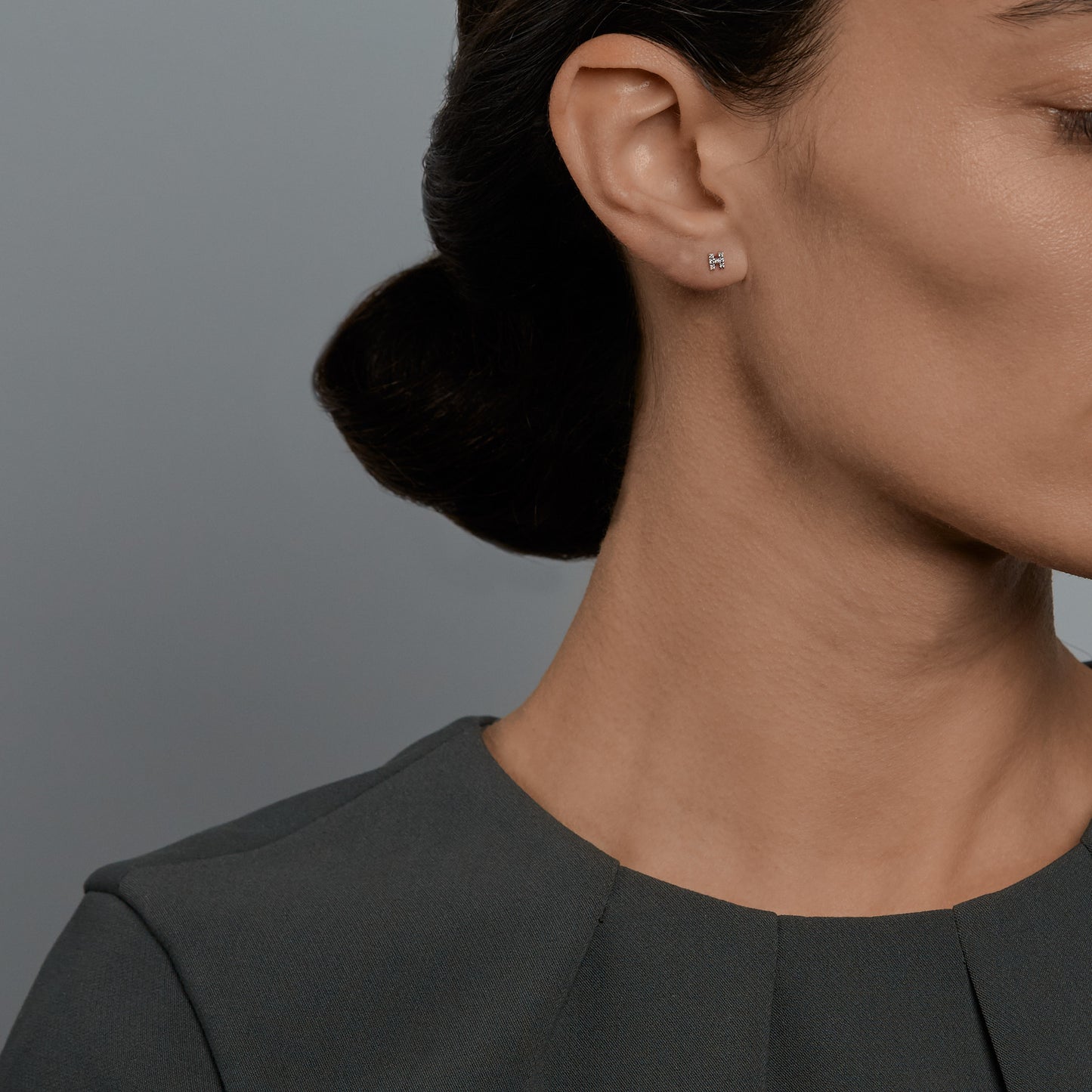 Woman wearing the Oliver Heemeyer Letter diamond ear studs. Letter: H