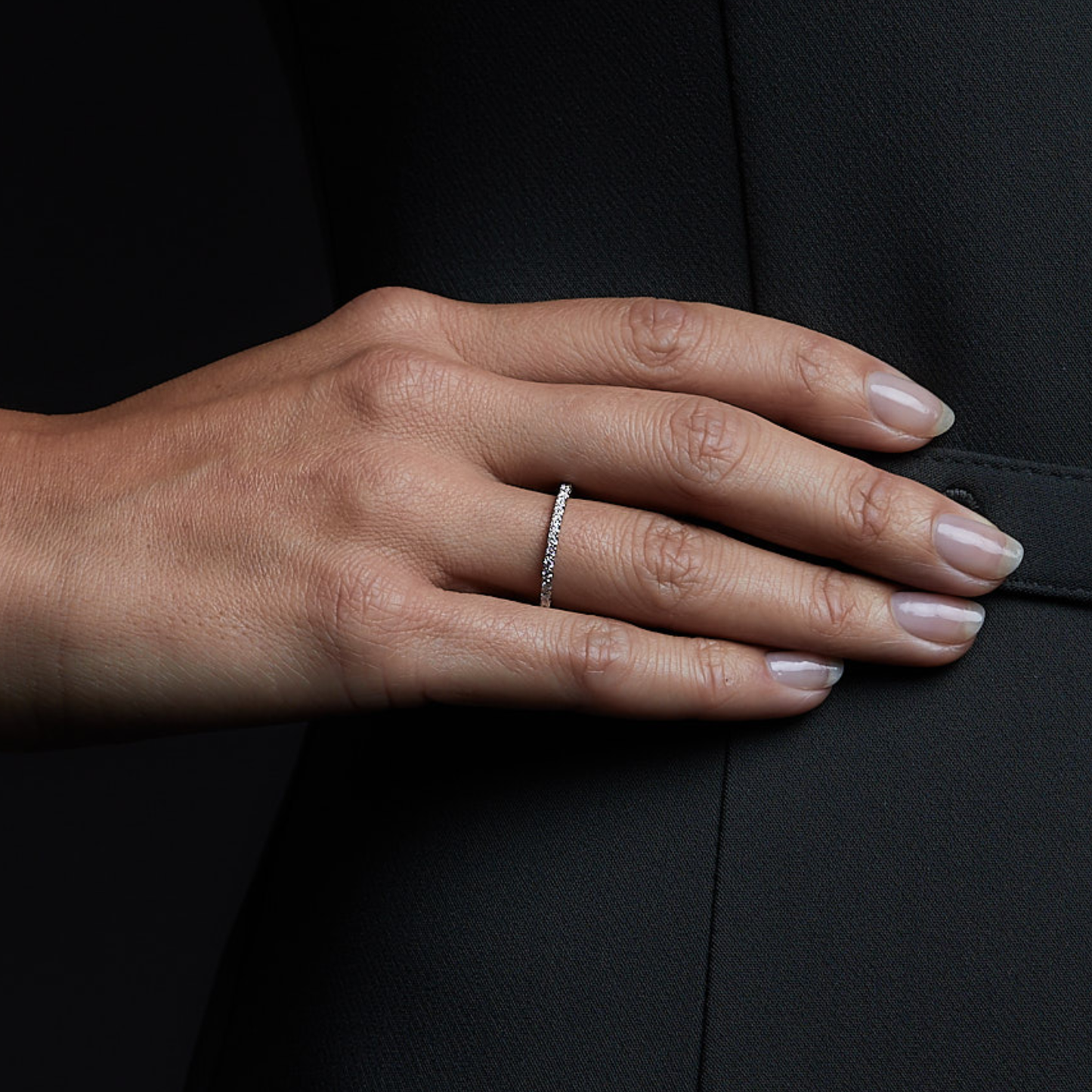 Woman wearing the Oliver Heemeyer Eternity Diamond Ring made of 18k white gold. Close up.
