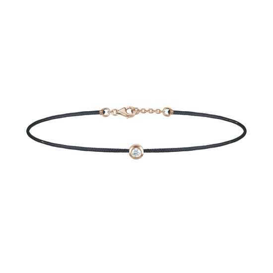 Oliver Heemeyer Solitaire diamond charm bracelet crafted in 18k rose gold carrying a solitaire diamond. An alluring every day piece of jewellery finished off with an OH pendant. Adjustable length. Colour: Black.