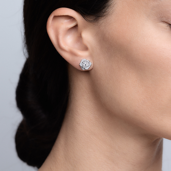 Woman wearing the Oliver Heemeyer Water Lily Diamond Ear Studs made of 18k white gold.