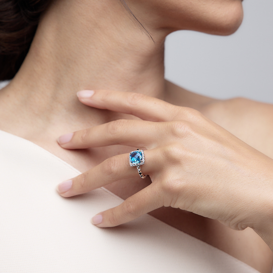 Woman wearing the Oliver Heemeyer Charlie Swiss Blue Topaz Ring Fancy made of 18k white gold.
