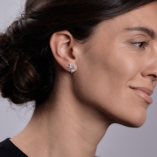 Woman wearing the Oliver Heemeyer Stars Diamond Ear Studs made of 18k white gold.