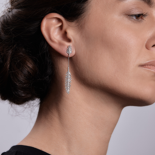 Woman wearing the Oliver Heemeyer Swan feather diamond earrings.