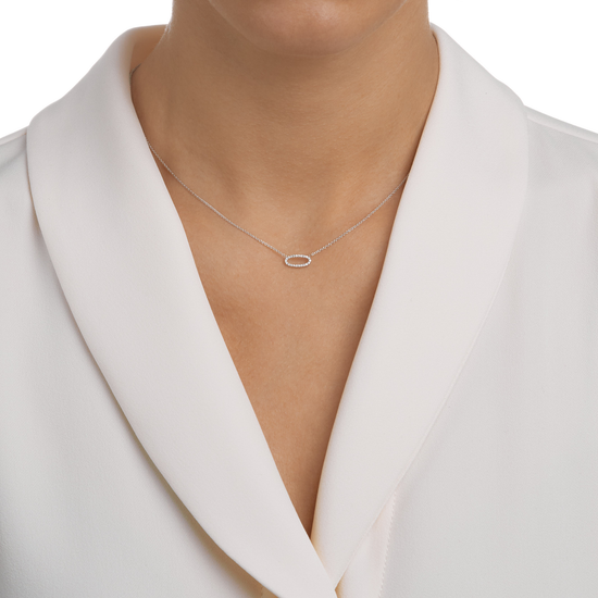Woman wearing the Oval Diamond Necklace in 18k white gold.