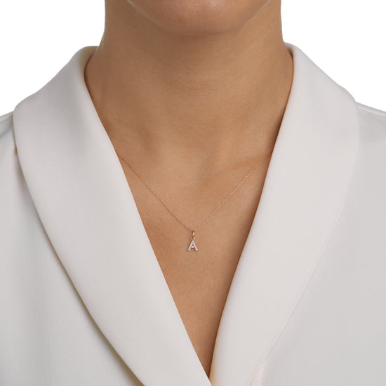 Woman wearing the Oliver Heemeyer Letter diamond necklace.