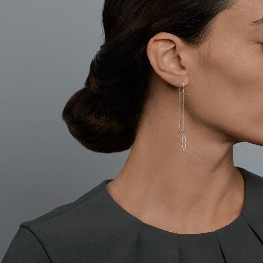 Woman wearing the Oliver Heemeyer Oriental chain diamond earrings in 18k white gold.