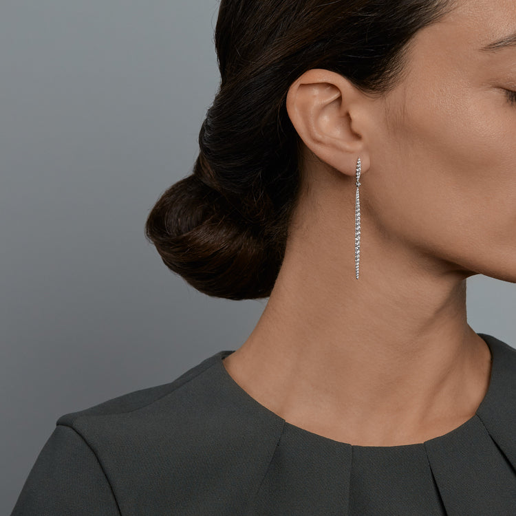 Woman wearing the Oliver Heemeyer Sword diamond earrings.