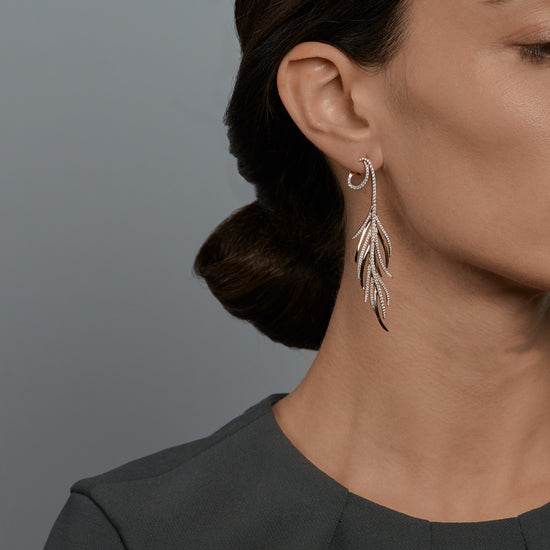Woman wearing the Oliver Heemeyer Feather diamond earrings.