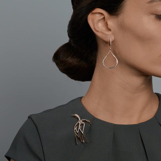 Woman wearing the Oliver Heemeyer Splash diamond earrings.