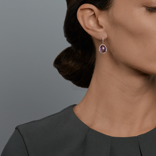 Woman wearing the Oliver Heemeyer Jamie Amethyst Earrings made of 18k rose gold.