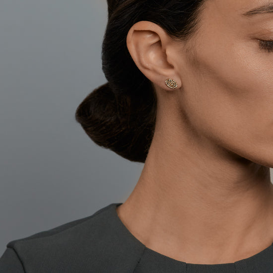 Woman wearing the Oliver Heemeyer Oval diamond ear studs.