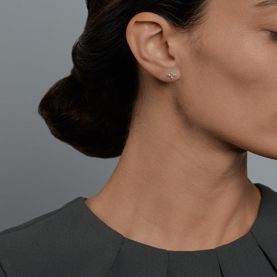 Woman wearing the Oliver Heemeyer Marquise diamond ear studs.