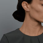 Woman wearing the Oliver Heemeyer Letter diamond ear studs. Letter: H