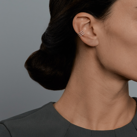 Woman wearing the Oliver Heemeyer Lilly Diamond Ear Cuff 3 Row made of 18k rose gold.