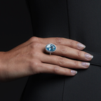 Woman wearing the Oliver Heemeyer Aquamarine diamond ring in 18k white gold. Close up.