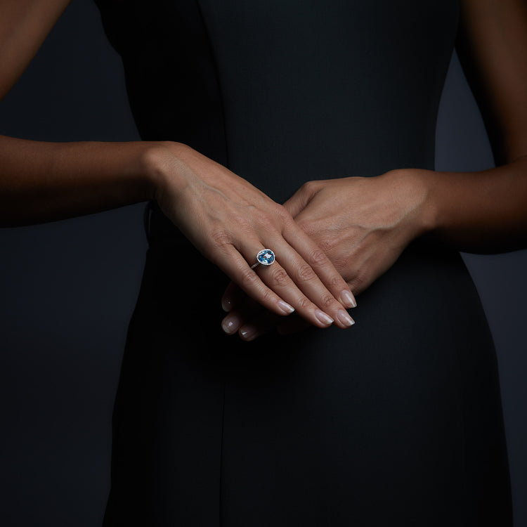 Woman wearing the Oliver Heemeyer Cocktail Ring Swiss Blue Topaz.