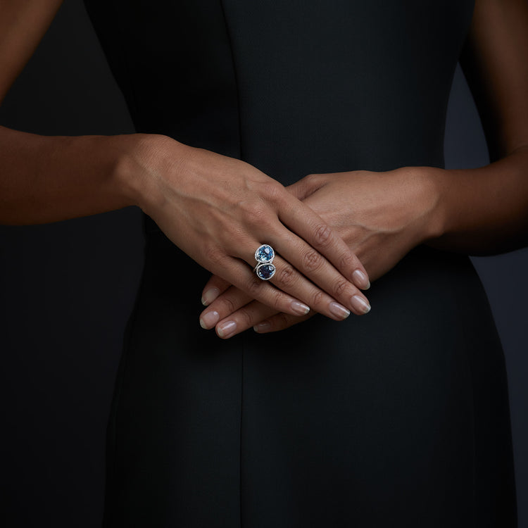 Woman wearing the Oliver Heemeyer Cocktail diamond ring in Swiss and London Blue. 