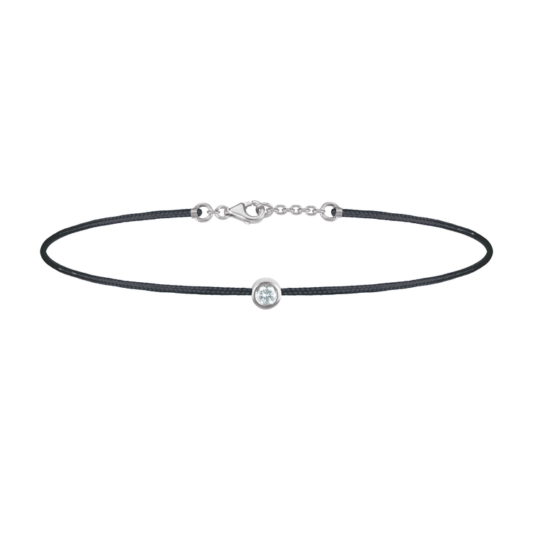 Oliver Heemeyer Solitaire diamond charm bracelet crafted in 18k white gold carrying a solitaire diamond. An alluring every day piece of jewellery finished off with an OH pendant. Adjustable length. Colour: Black.